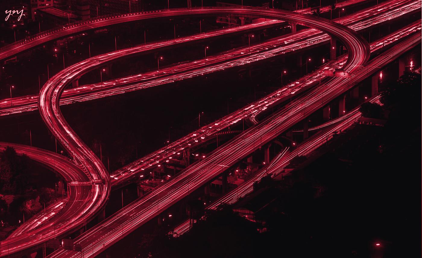 Night highway interchange with light trails