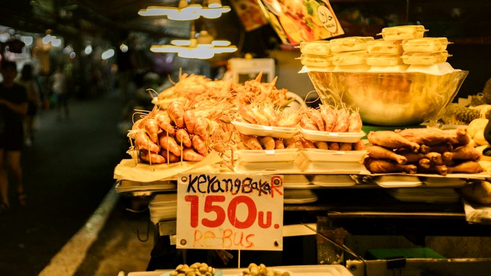 A market stall with a handwritten price card.
